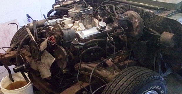 Pontiac Firebird 1968 engine compartment with radiator removed for engine removal.