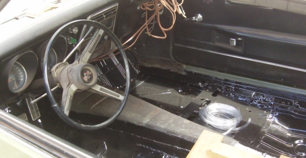 A fully restored 68 Firebird floorboard with seat supports.